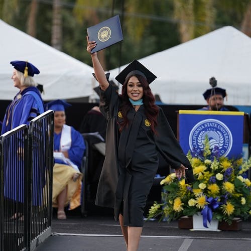 Graduate student walking on stage